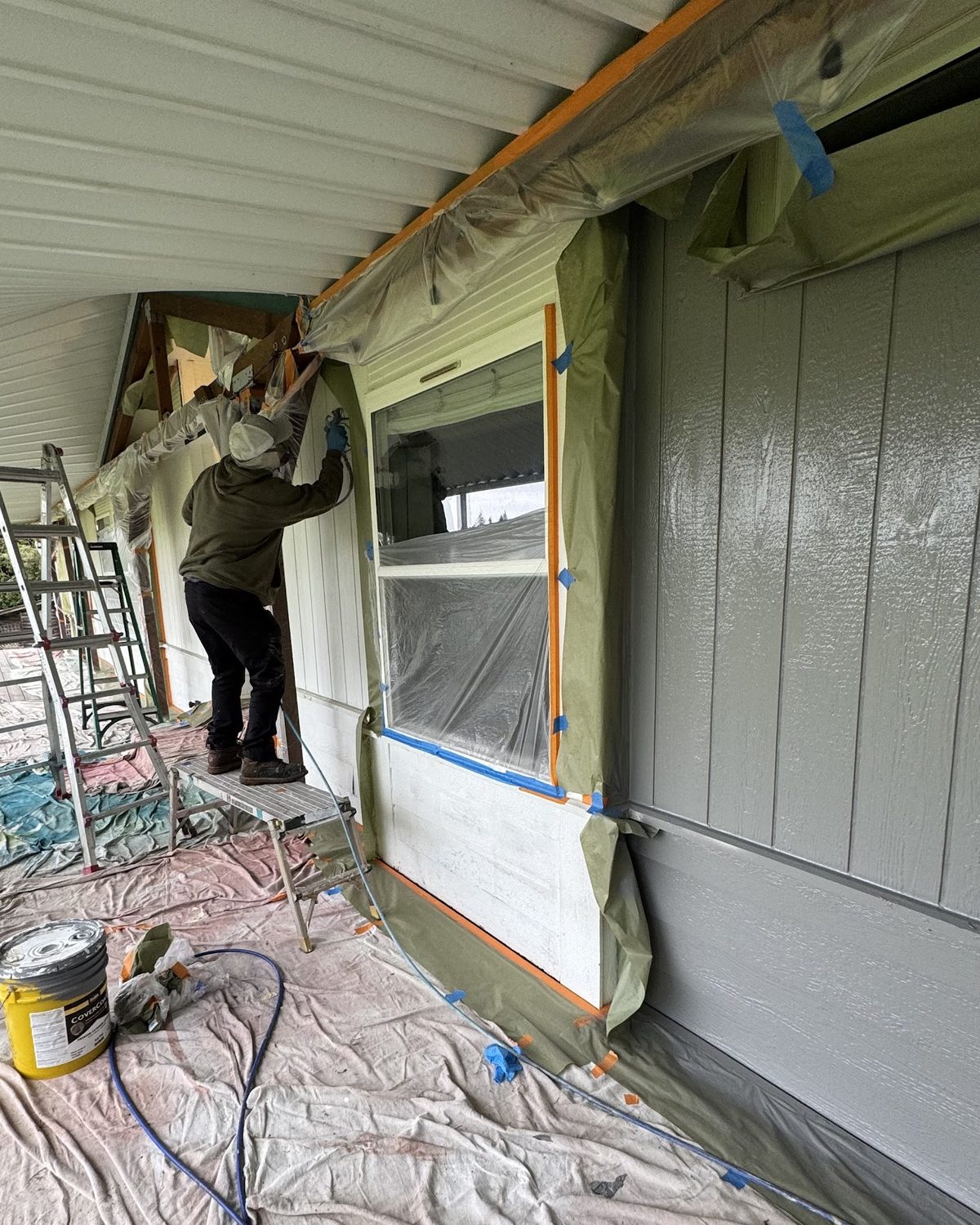 Coastside Contracting masking and spraying an exterior repaint