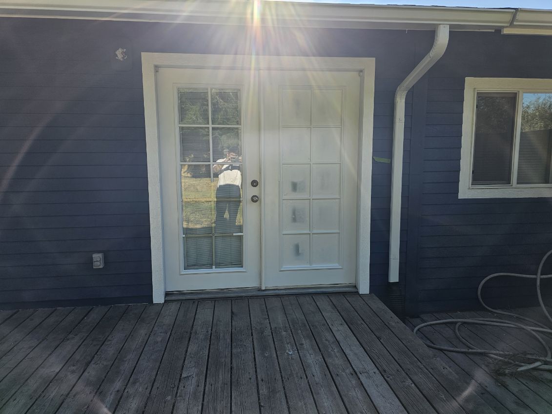 Freshly repainted navy blue exterior with new French doors and back deck